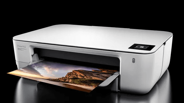Printer on a desk with a printed photo